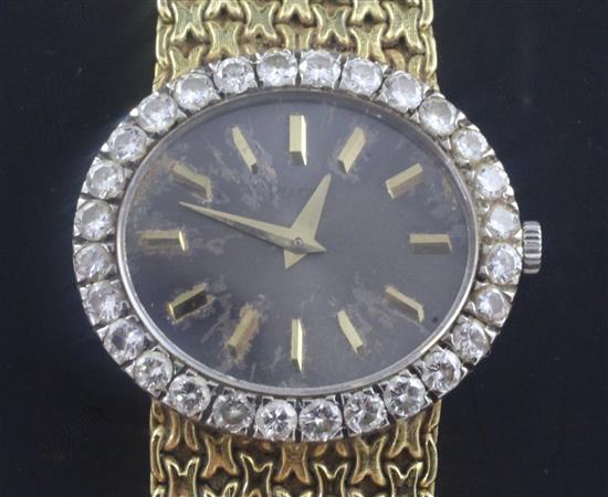 A ladys 18ct gold Piaget manual wind dress wrist watch with diamond set bezel, with Piaget box.